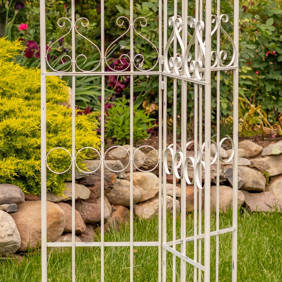Bottom of 7.7ft Tall Three Wall Folding Iron Trellis with Fleur-de-lis Accents Paris 1968 with a distressed, hand painted Antique white finish. Image shows middle section of trellis
