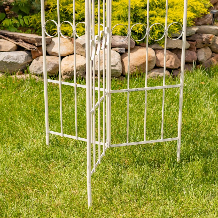Bottom of 7.7ft Tall Three Wall Folding Iron Trellis with Fleur-de-lis Accents Paris 1968 with a distressed, hand painted Antique white finish. Image shows how there are three stakes that penetrate the ground enabling the trellis to stand freely and securely on its own