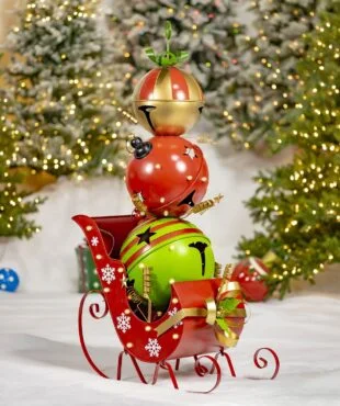 This is a tall metal Christmas decoration made of big bells stacked in a tower. It’s almost as tall as a person and feels smooth and cool. The shape is narrow and gets smaller at the top, like a cone. It feels strong and is used to decorate for the holidays.