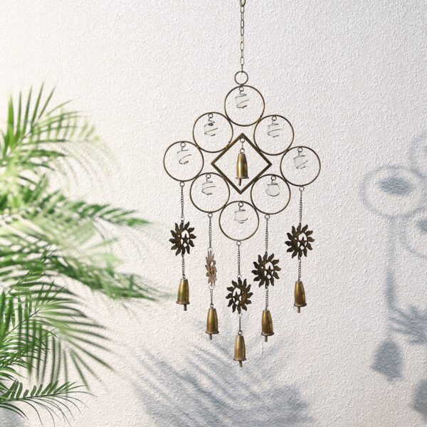 It’s a metal wind chime with round shapes and small bells hanging down. The pieces are arranged in a neat pattern and move when the wind blows.